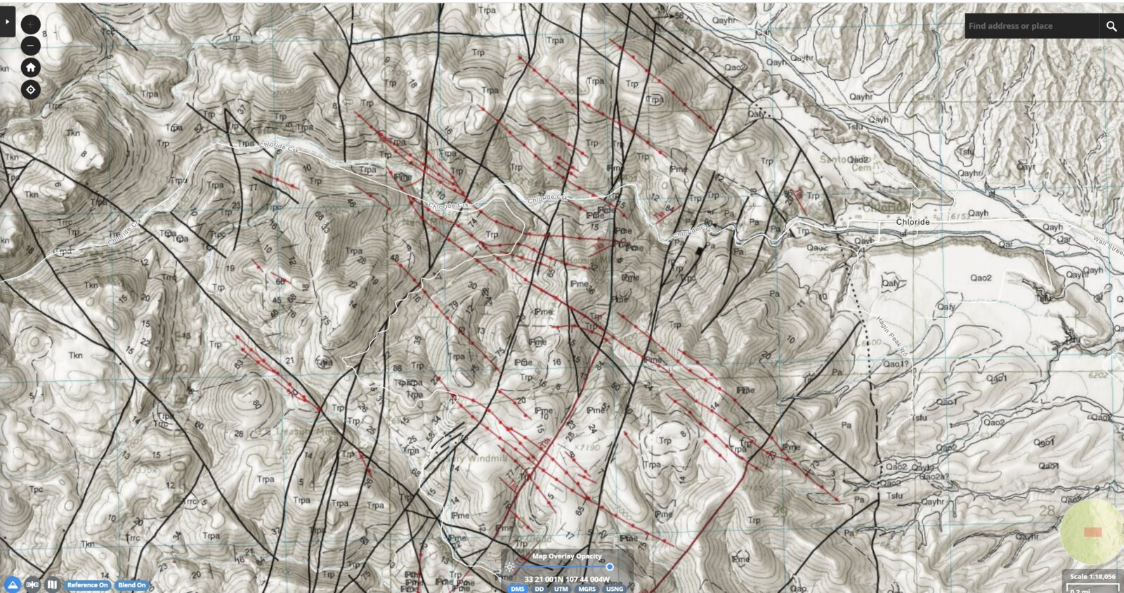 PetraMapper showing a USGS topographic map with a geology overlay and red strike-and-dip survey lines across a mining district.